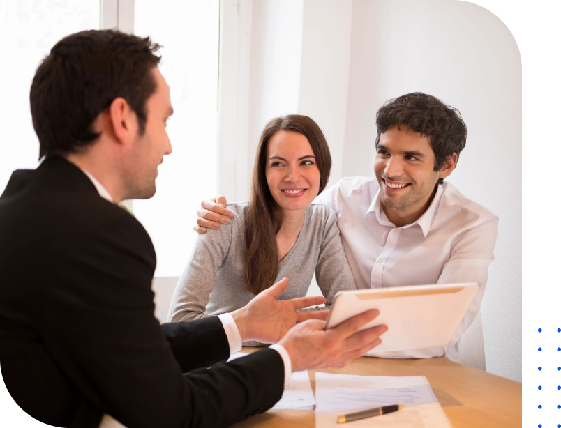 A couple of people sitting at a table with papers.